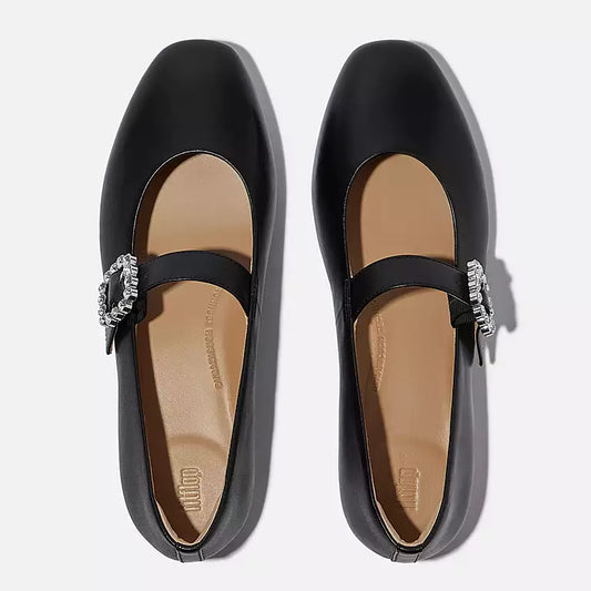 Pair of black shoes with decorative straps on a white background