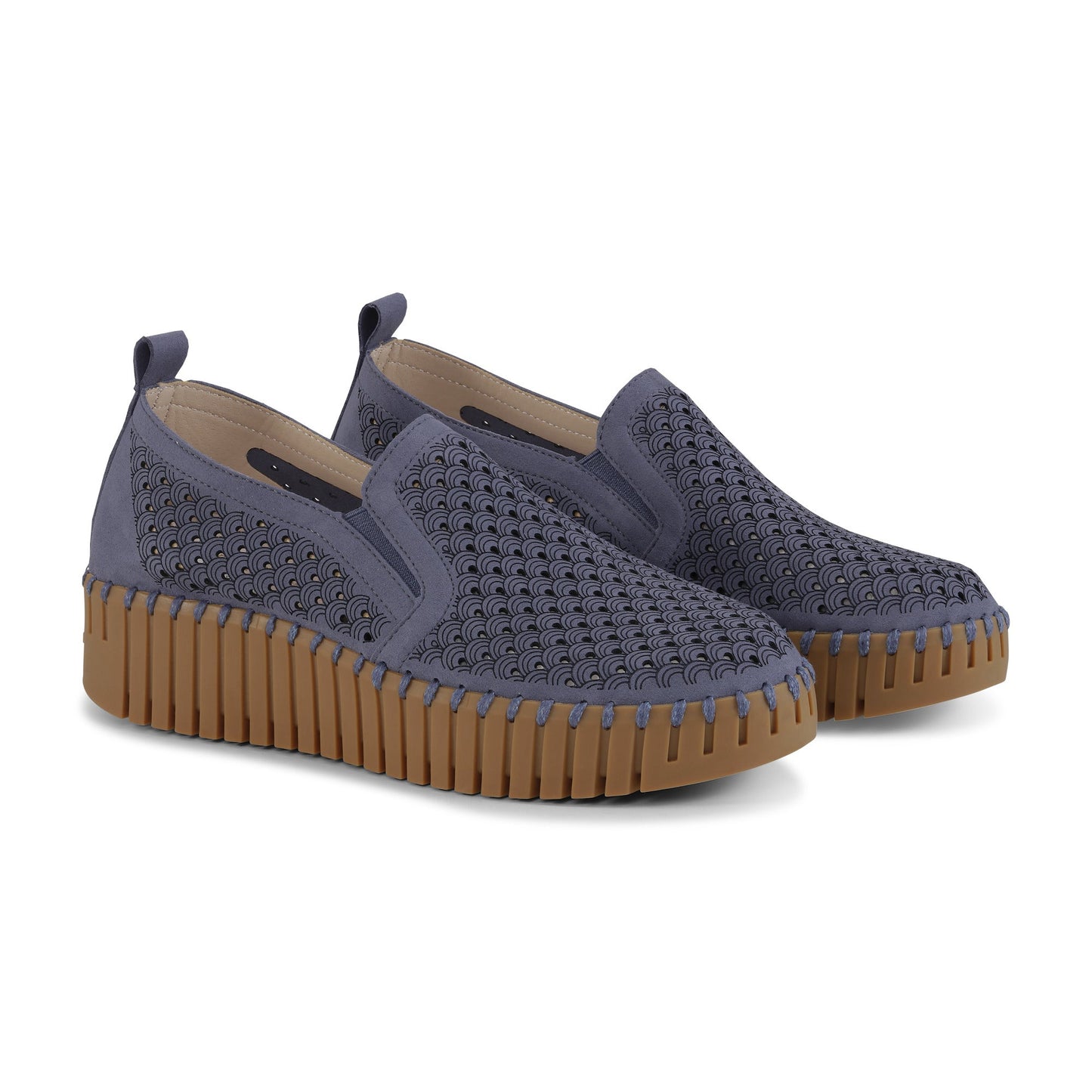 Pair of blue slip-on shoes with brown soles on a white background
