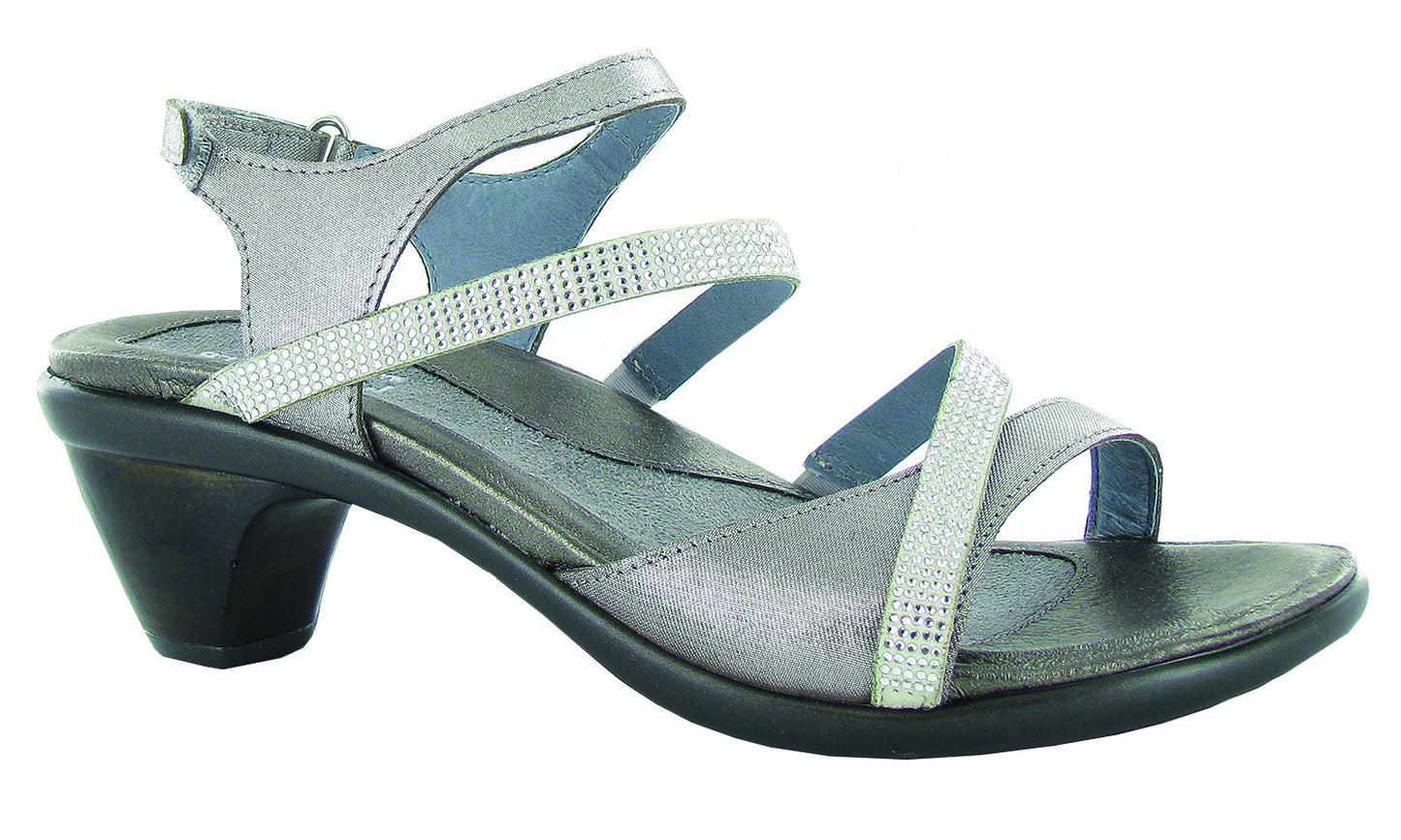 A silver-colored sandal with a hook and loop backstrap, padded front strap, and rhinestone accents.