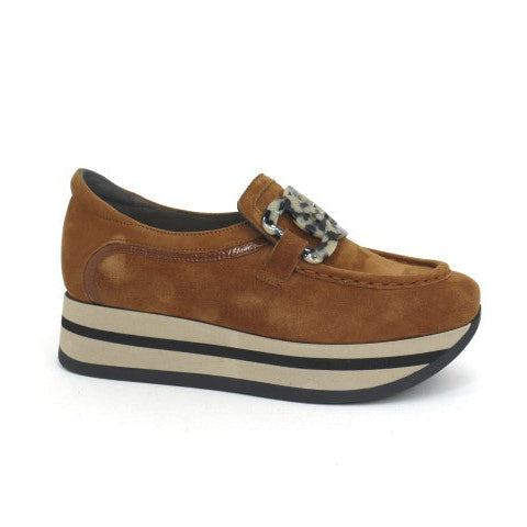 Brown platform shoe with a decorative element on a white background