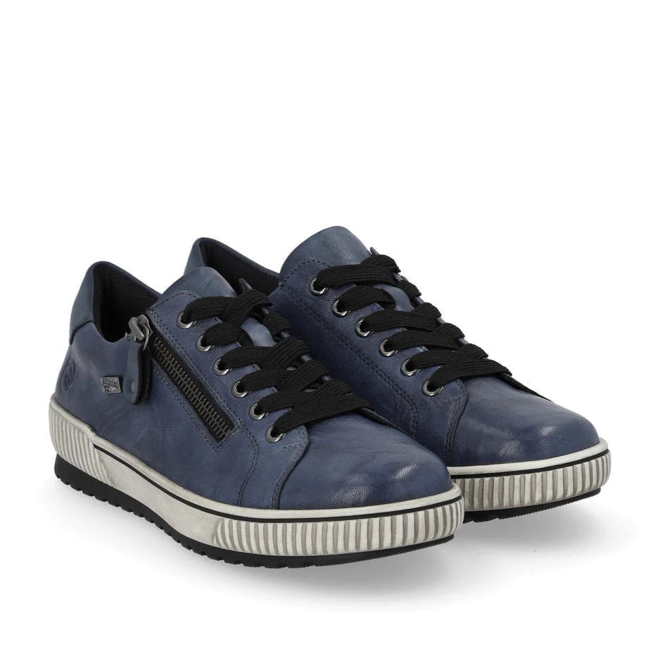 Pair of blue sneakers with black laces on a white background