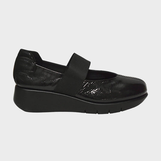 Black shoe with a strap on a light gray background