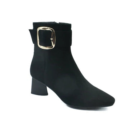Black ankle boot with gold buckle on a white background