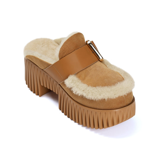 Brown platform shoe with fur lining on a white background