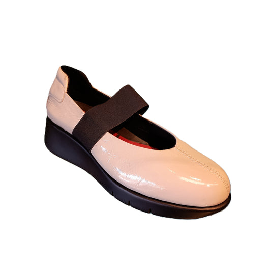 Cream-colored shoe with a black sole and strap on a white background
