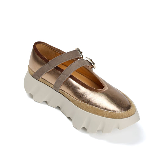 Gold platform shoe with beige sole on a white background