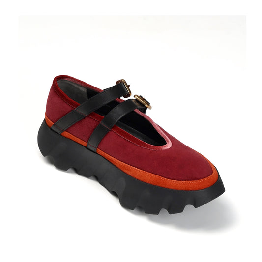 Red and black shoe with a thick sole on a white background