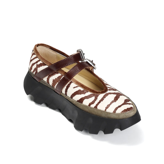 Zebra-patterned shoe with brown accents on a white background